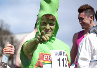 Man dressed as a beer bottle for charity.