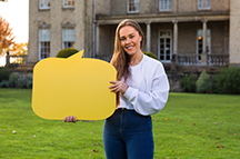 Student holding a speech bubble