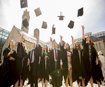 Students throwing caps in air at NTU graduation