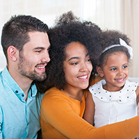 Father, mother and daughter taking a selfie