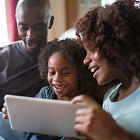 Couple and child looking at ipad