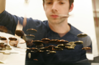 A student dropping money onto a desk