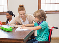 Teacher with pupil in wheelchair